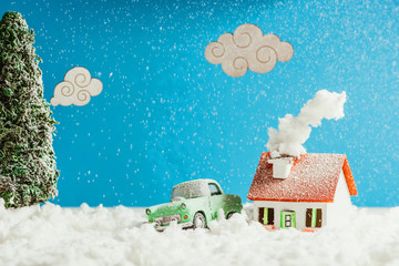 Wall Mural - close-up shot of toy car and house covered with snow, christmas concept