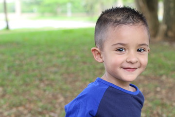 hispanic child smiling in the park