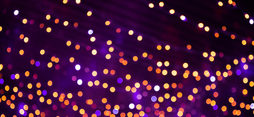 Wall Mural - multicolored holiday background with bright bokeh lights.