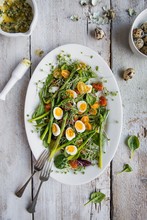Spring Salad With Asparagus, Tomatoes, Cress, Spinach, Quails Eggs And Basil Pesto, View From Above