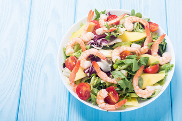 Wall Mural - Mix of salad with shrimps , avocado and cherry tomatoes . Healthy food background