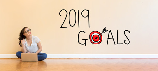 Poster - 2019 Goals text with young woman using a laptop computer on floor