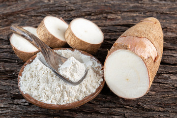 Wall Mural - Raw yucca starch on the wooden table - Manihot esculenta.