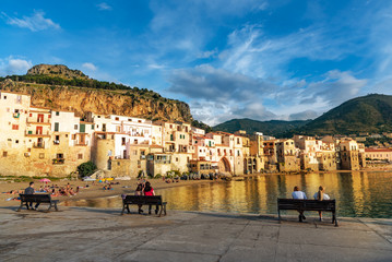 Wall Mural - People enjoying summer holiday in Cefalu town on the beach, in Sicily island, Italy