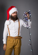 Man with a garland for Christmas fir