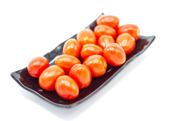 Fresh Tomato in a ceramic cup isolated white background 