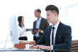 © yurolaitsalbert - employee sitting behind a Desk in the office .