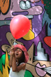 Girl playing with balloons in the park. Birthday.