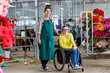 © Stocksy - Female Worker Standing By Disabled Colleague In Greenhouse