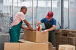 © Stocksy - Workers Packing Cardboard Box At Warehouse In Greenhouse