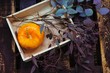 © Stocksy - From above shot of wooden box with little pumpkin and eucalyptus branch