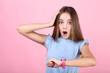 © 5second - Young surprised girl with wrist watch on pink background