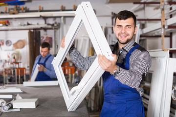 Wall Mural - happy male professional labours with finished PVC profiles and windows