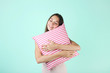 © 5second - Young girl with pillow on mint background
