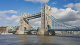 Fototapeta Londyn - London under a moody sky. View of Tower bridge across the river Thames.