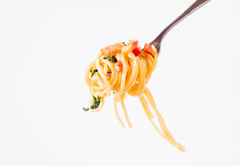 Wall Mural - Spaghetti Carbonara with some parsley on a fork on a white background