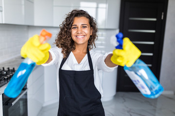 Wall Mural - Young latin Woman cleaning kitchen. Young woman washing kitchen hood