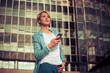 © Dalibor Danilovic - Stylish business woman texting in front of the office building