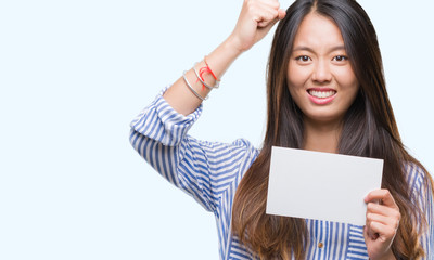 Poster - Young asian woman holding blank card over isolated background annoyed and frustrated shouting with anger, crazy and yelling with raised hand, anger concept