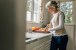 © Jacob Lund - Senior woman working in kitchen at home