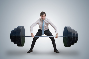 Young businessman in shirt is lifting heavy weights.