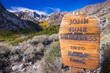 Sign posted at the entrance to the John Muir Wilderness, in the Inyo National Forest; Eastern Sierra mountains, California; McGee valley visible in the background; beautiful sunny fall day