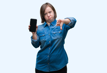 Sticker - Young adult woman with down syndrome showing smartphone screen over isolated background with angry face, negative sign showing dislike with thumbs down, rejection concept