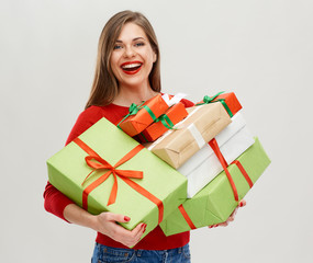 caucasian smilimg woman holding heap of gift boxes.