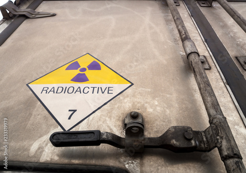 Fotomural Radiation warning sign on the Dangerous goods transport label Class 7 at the con