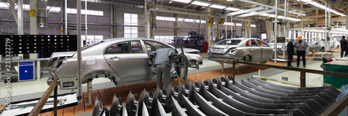 Fotomural Engineer looks into the cab of the car on the production line