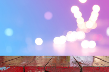Canvas Print - wooden desk with blurred light bokeh abstract background