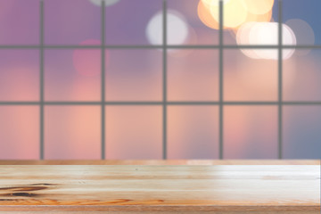 Canvas Print - wooden desk with blurred light bokeh abstract background