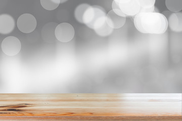 Canvas Print - wooden desk with blurred light bokeh abstract background