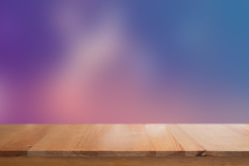 Canvas Print - wooden desk with blurred light on road in city with bokeh abstract background