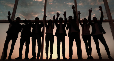 Wall Mural - silhouette of a group of business people raising their hand