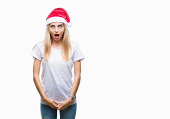 Canvas Print - Young beautiful blonde woman christmas hat over isolated background afraid and shocked with surprise expression, fear and excited face.