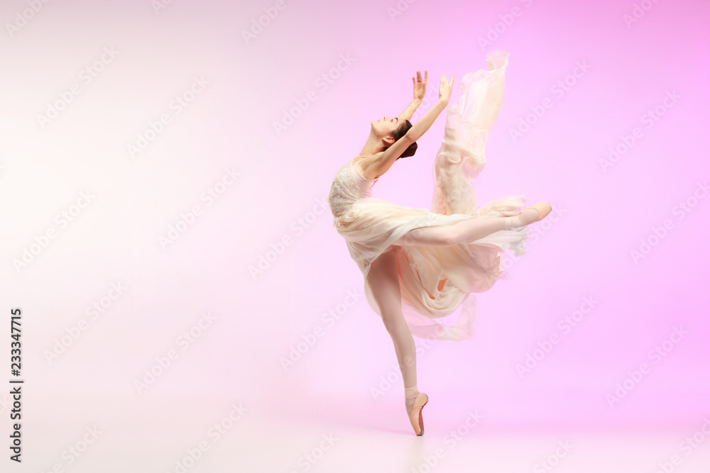 Young graceful female ballet dancer or classic ballerina dancing at pink studio. Caucasian model on pointe shoes - obrazy, fototapety, plakaty 