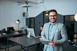© bnenin - Portrait of a smiling handsome business man in coworking office. Looking at camera.