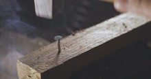 Hammering The Nail To The Wood