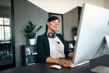 Canvas Print - Taking a break. Relaxed woman at office desk.