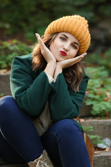 Sticker - Beautiful young woman sitting on stairs outdoors