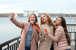 © Pixel-Shot - Beautiful young women taking selfie while drinking champagne outdoors