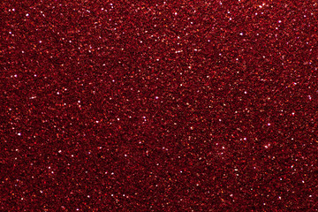 Dark red sparkling background from small sequins, closeup. Brilliant backdrop.