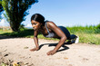 © Westend61 - Young athlete doing push ups on the dirt track
