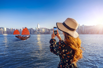 Woman take a photo at Hong Kong.