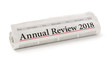 Rolled newspaper with the headline Annual review 2018