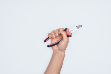 Wall Mural - cropped shot of man holding pliers isolated on white