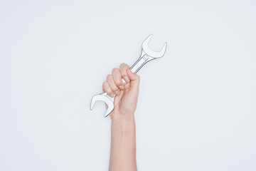 Wall Mural - cropped shot of woman holding wrench isolated on white