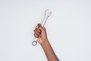 Wall Mural - cropped shot of african american man holding wrench isolated on white