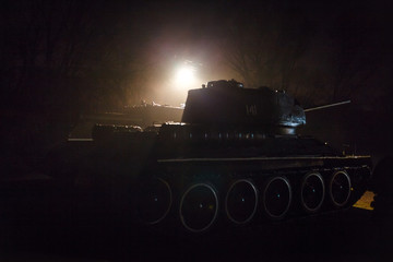 War Concept. Military silhouettes fighting scene on war fog sky background, World War Soldiers Silhouettes Below Cloudy Skyline at sunset. Attack scene. Armored vehicles. tank in action